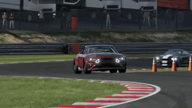 a red car is driving on a race track