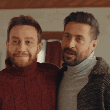 two men are standing next to each other and one has a beard