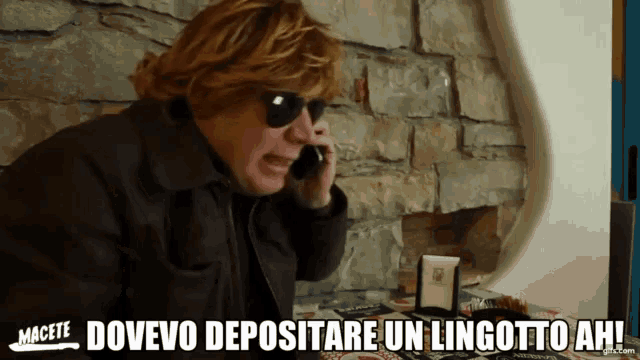 a man talking on a cell phone with the words dovevo depositare un lingutto ah