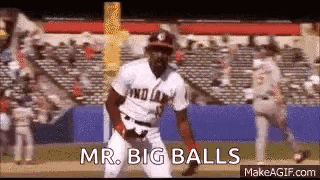 a man in a baseball uniform is standing on a baseball field and says `` mr. big balls '' .