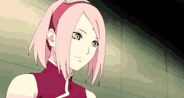 a close up of a pink haired anime girl with a headband on her head .