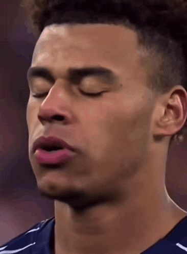 a close up of a man 's face with his eyes closed .