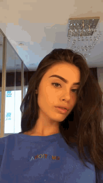 a girl wearing a blue shirt that says ahom3 on it