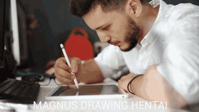 a man is drawing on a tablet with the words magnus drawing hentai behind him