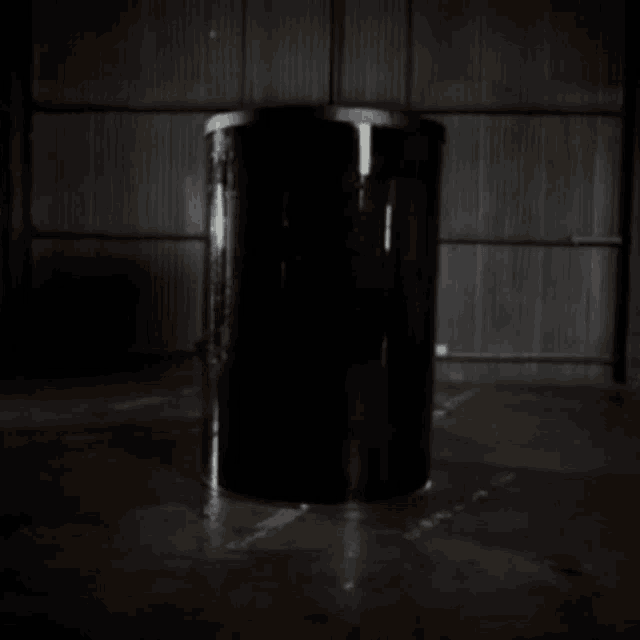 a black cylinder with a hand print on the side of it