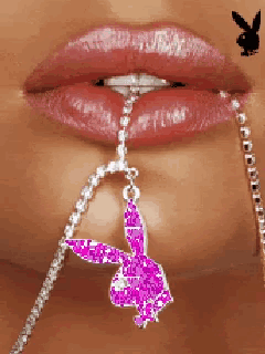 a close up of a woman 's mouth with a pink playboy bunny necklace