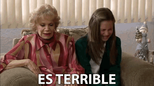 an older woman and a young girl sit on a couch with the words es terrible behind them