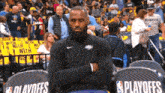 a man with a beard is sitting in a playoffs chair .