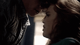 a man and a woman are touching each other 's faces .
