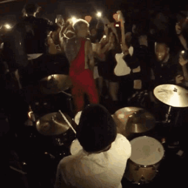 a drummer playing in front of a crowd of people