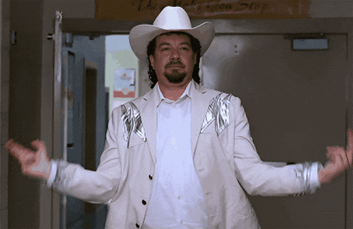 a man wearing a cowboy hat and a silver jacket