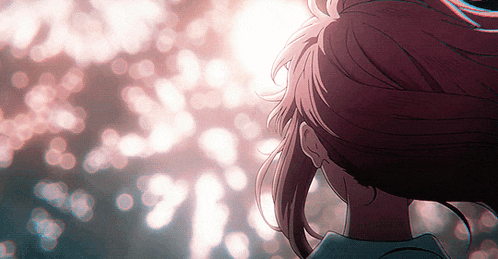 a close up of a person 's head with the sun shining through the trees