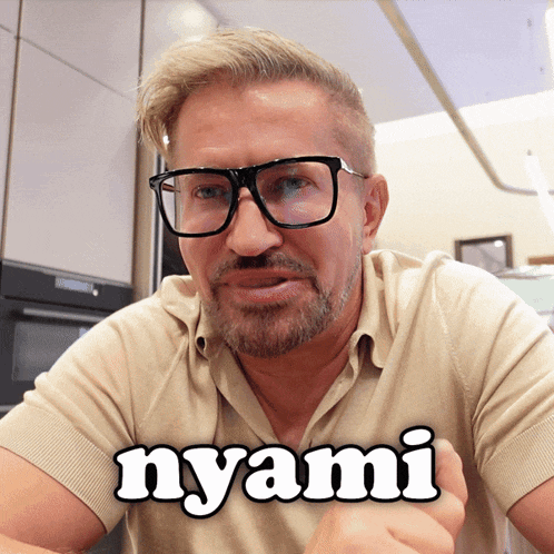 a man wearing glasses and a shirt that says " nyami "