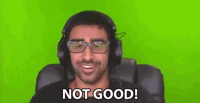 a man wearing headphones and glasses is sitting in a chair and says `` not good '' .
