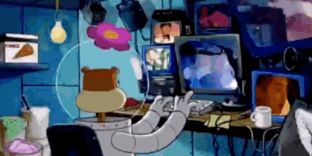 a cartoon character is sitting at a desk in front of a bunch of monitors