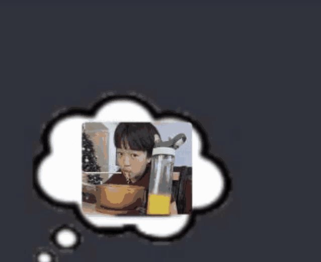 a young boy is eating cereal and drinking orange juice from a bottle .