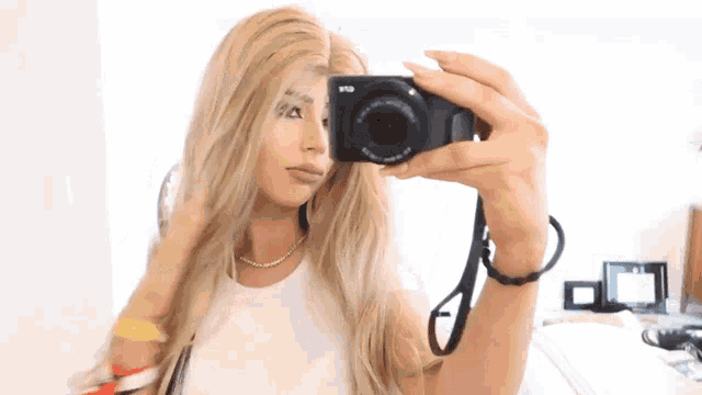 a woman is taking a picture of herself with a camera that says ' lg ' on it