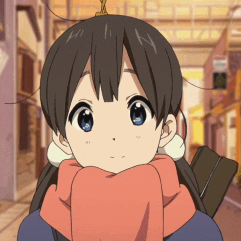 a girl with a scarf around her neck has a letter n on her head