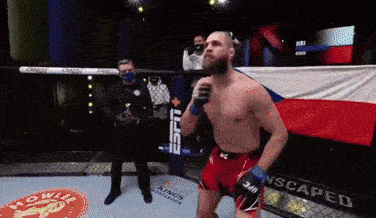 a man in a boxing ring with a banner that says scaped on it