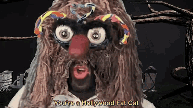 a cartoon character says " you 're a hollywood fat cat " in a graveyard