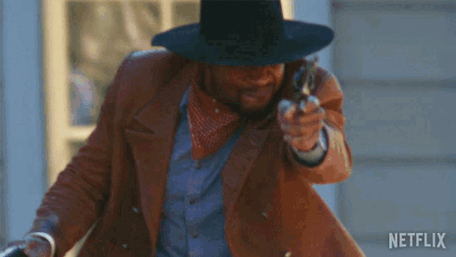 a man in a cowboy hat is pointing a gun with a netflix logo in the background