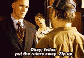 a man in a suit and tie says okay fellas put the rulers away zip up .