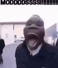 a man with his mouth open and his tongue sticking out is standing in front of a building .