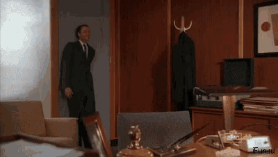 a man in a suit and tie is standing in a room with a sign that says ifup.ru on it