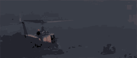 a military helicopter is flying over a desert at night .