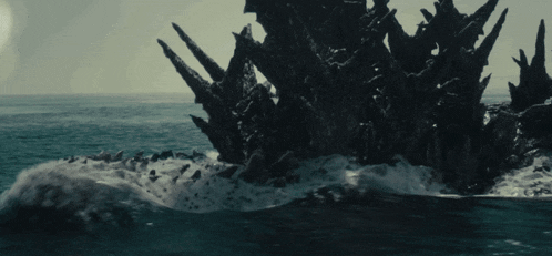 a monster is coming out of the ocean
