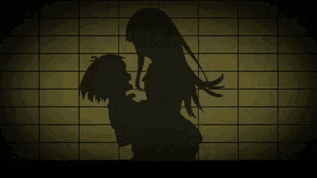 a silhouette of a woman holding a child against a tiled wall .