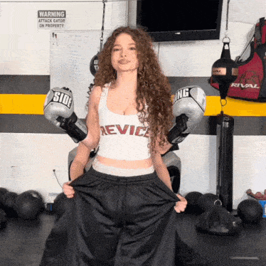 a woman is wearing boxing gloves that say side