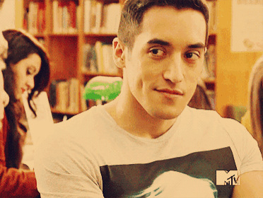 a man wearing a t-shirt with a mtv logo on the sleeve