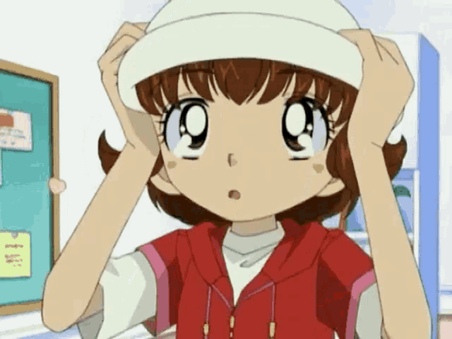 a girl wearing a red jacket and a white hat looks surprised