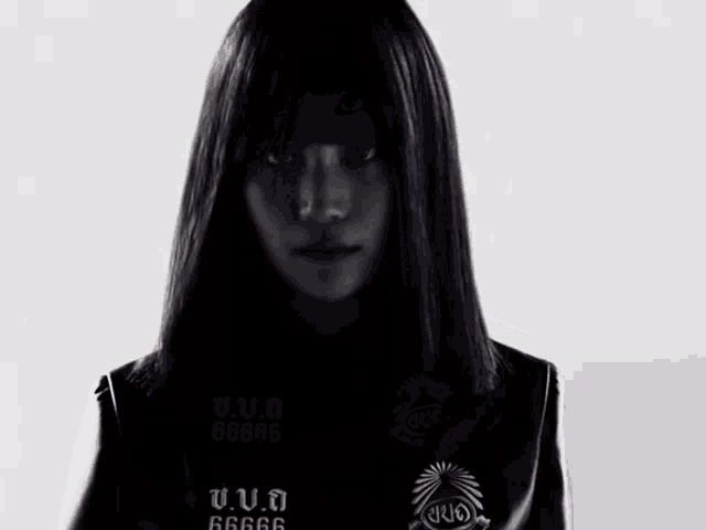 a black and white photo of a woman wearing a jacket that says 6666