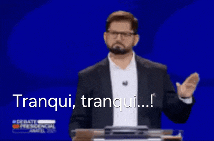 a man in a suit and glasses is giving a speech at a podium and says tranquil , tranquil ...