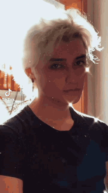 a tik tok video of a young man with blonde hair