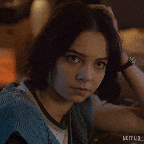 a close up of a woman 's face with a netflix logo in the background