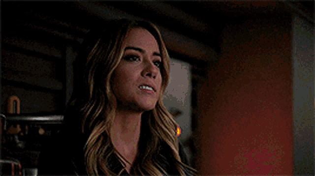 a close up of a woman 's face with a serious look on her face .