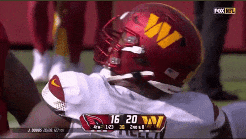 a football player wearing a helmet that says ' washington redskins '