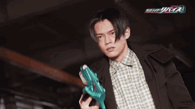 a man in a plaid shirt is holding a gun and the word rider is on the bottom right
