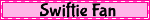 a pink sign that says swiftie fan is blurred