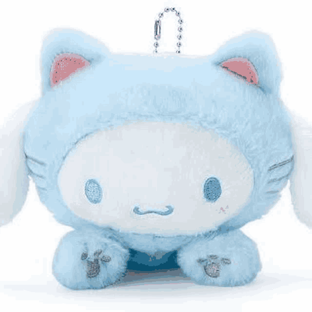 a blue and white cat stuffed animal with a keychain attached to it .