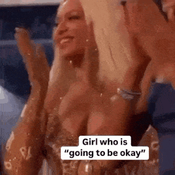 a woman in a very revealing dress is applauding and smiling .