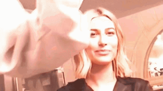a close up of a woman 's face with a person 's hand touching it .