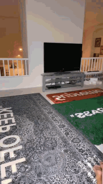 a living room with a rug that says " keep out " on it