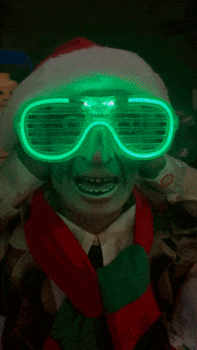 a man wearing a santa hat and glowing glasses