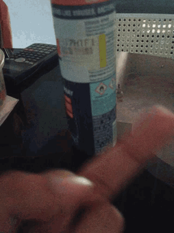 a person is holding a spray bottle that says ' thomson ' on the front