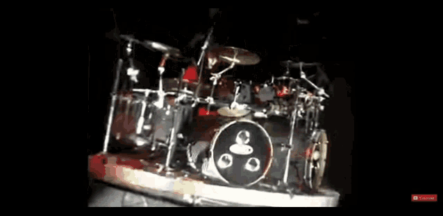 a drum set on a stage with a drummer playing it .