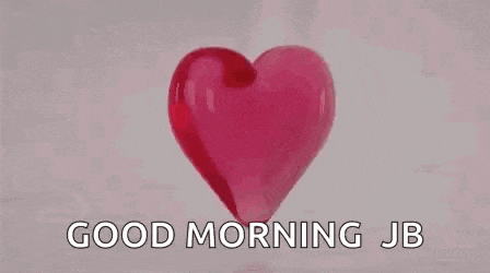 a stack of red gummy hearts with the words `` good morning jb '' written on them .
